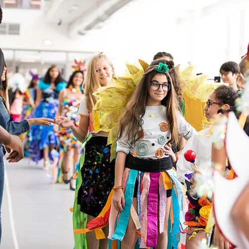 Students in bright festival costumes at the arts festival